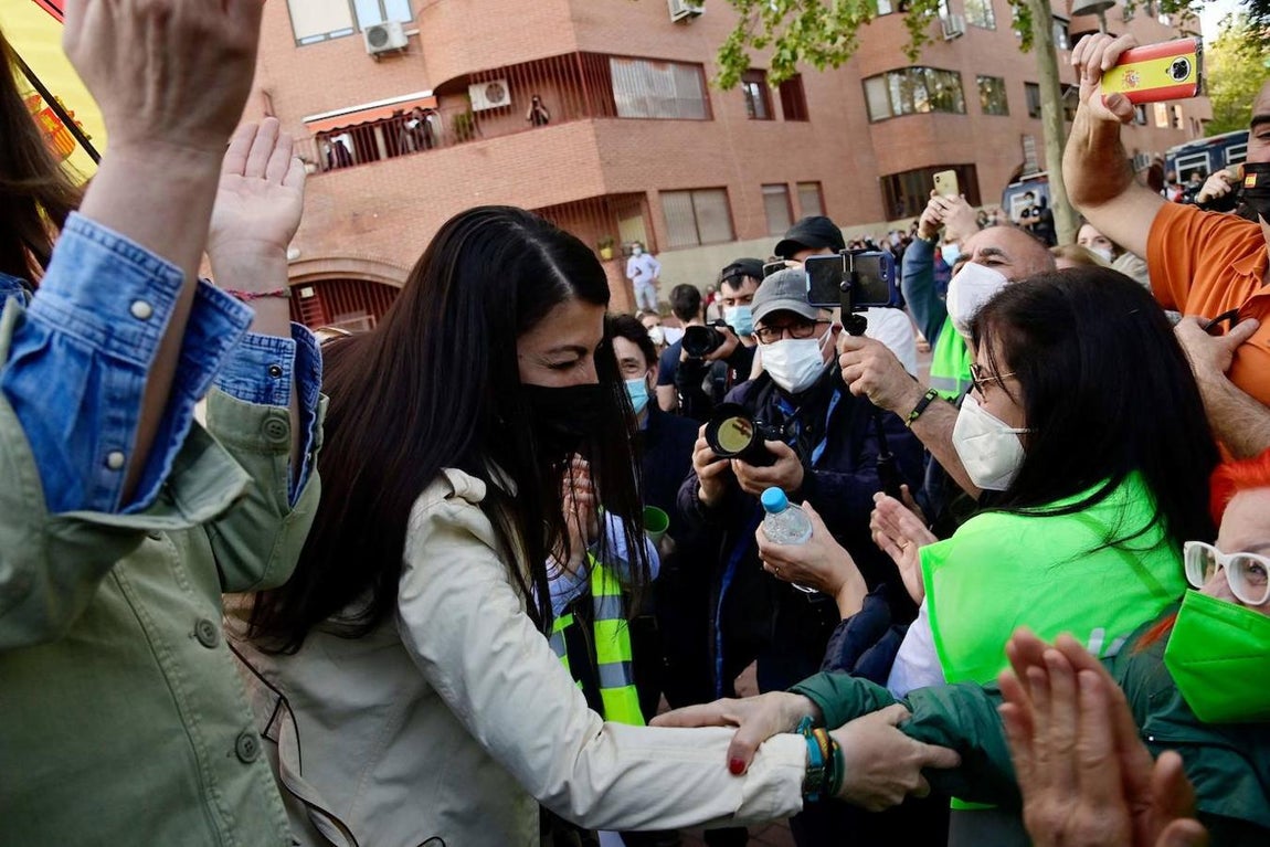 Macarena Olona (C) da la mano a una simpatizante durante la presentación del candidato de Vox para las elecciones regionales de Madrid. 