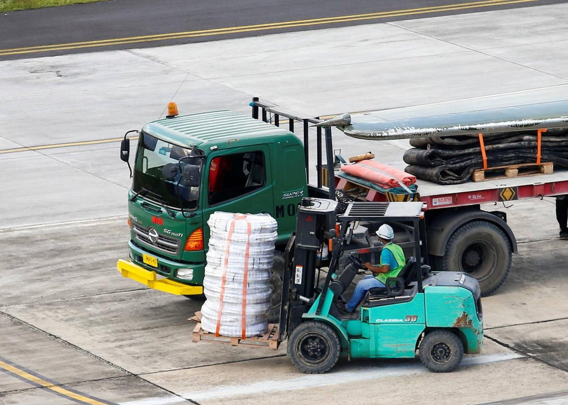 Un oficial organiza el equipo entregado por el avión de la Fuerza Aérea de Indonesia, mientras continúa la búsqueda del submarino. 