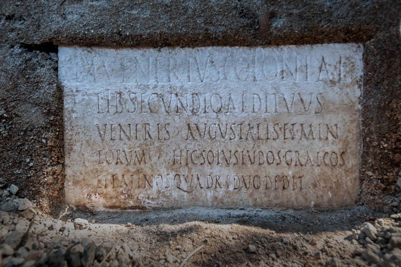 La gran losa de mármol colocada en la tumba, con una inscripción conmemorativa del propietario, Marcus Venerius Secundio, alude a la realización en Pompeya de espectáculos en griego. 