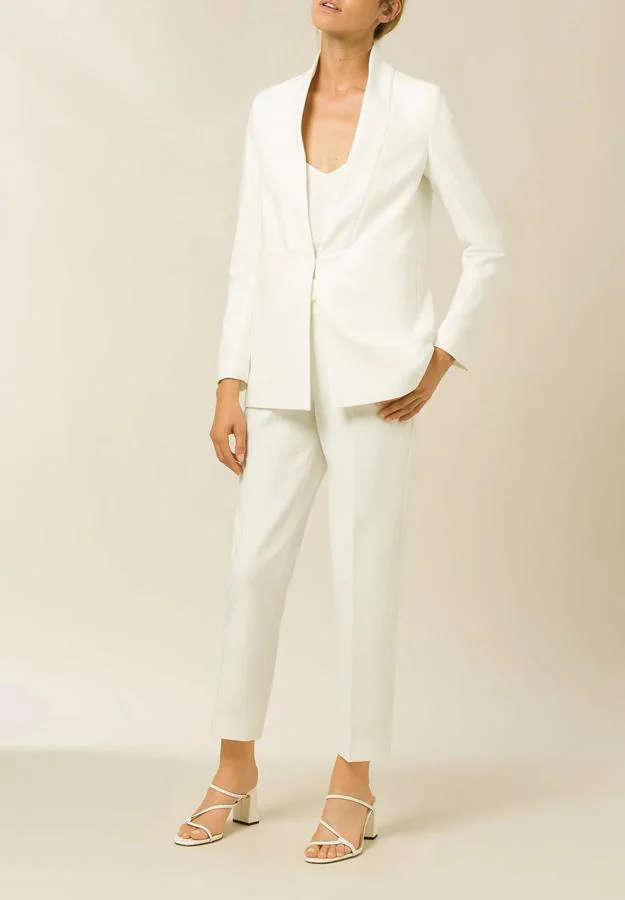 Ivy Oak - Trajes de chaqueta blancos para la primavera y el verano. Un modelo con las solapas invertidas y un botón invisible, ideal para los eventos de día. Precio: 158€.