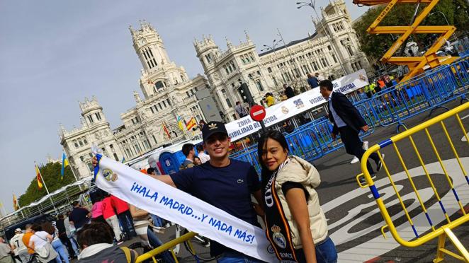 Una pareja de aficionados en la plaza de Cibeles antes del final del partido