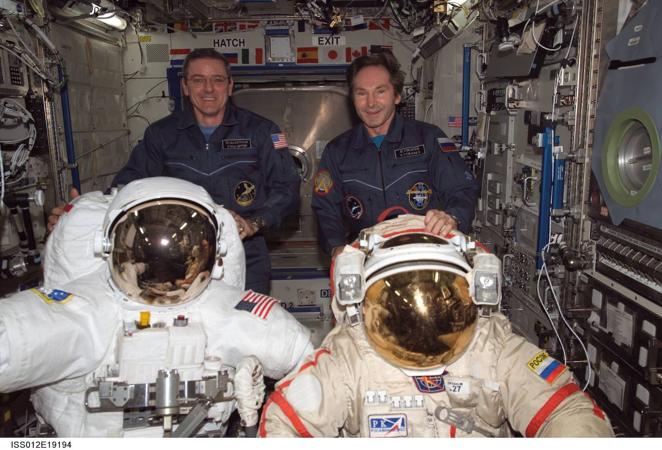 Los trajes que (ahora) quedan para la historia. El nombre formal de los trajes espaciales que se utilizan en el trasbordador espacial y en la Estación Espacial Internacional es Unidad de Movilidad Extravehicular (o EMU, por sus siglas en inglés). El traje espacial consta de varias partes: el torso superior rígido cubre el pecho del astronauta. El montaje para los brazos cubre los brazos y se conecta con los guantes. El casco y el visor extravehicular protegen la cabeza del astronauta y, a la vez, le permiten ver tanto como sea posible. La parte del torso inferior cubre las piernas y los pies del astronauta. Las partes flexibles del traje están hechas de varias capas de material. Las capas cumplen diferentes funciones, desde mantener el oxígeno dentro del traje hasta proteger del impacto del polvo espacial.En la parte de la espalda del traje hay una mochila llamada Subsistema Primario de Soporte de Vida. Esta mochila contiene el oxígeno que los astronautas respiran durante un paseo espacial y elimina el dióxido de carbono que los astronautas exhalan. La mochila también le da electricidad al traje. Un ventilador hace que el oxígeno circule por el traje espacial y los sistemas de soporte de vida, y un tanque de agua contiene el agua refrigerada que circula por el traje LCVG. En la imagen, el astronauta Bill McArthur (izquierda) y el cosmonauta Valery Tokarev muestran los trajes espaciales norteamericano (izquierda) y ruso.