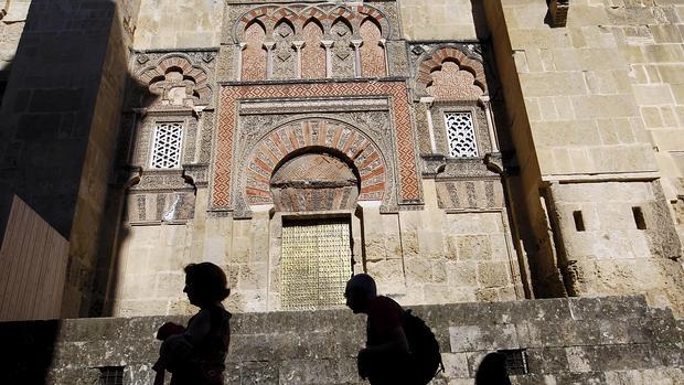 Dos personas pasan por delante de la Mezquita-Catedral