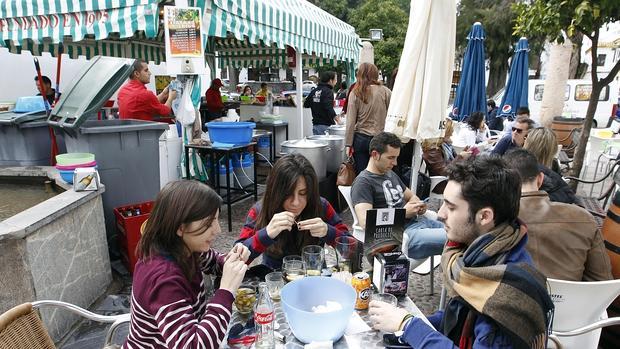 Comensales degustando caracoles en la plaza de la Magdalena