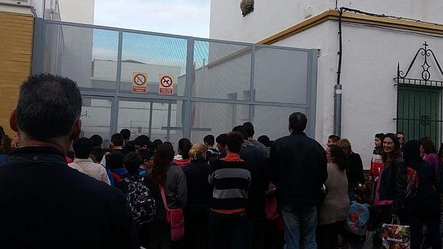 Padres y alumnos del colegio Fray Albino ante la puerta de entrada