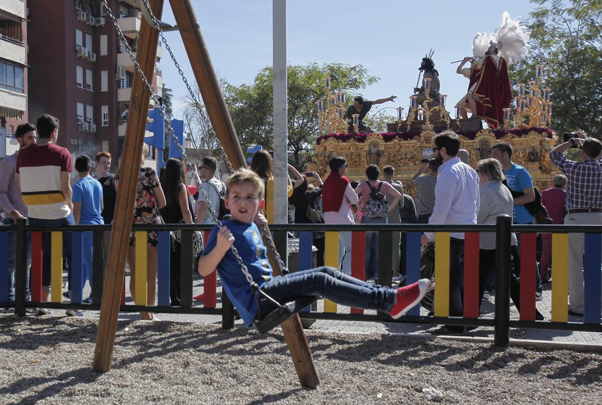 Un niño juega al paso de la hermandad de la Merced