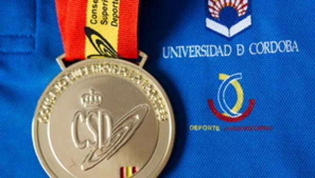 Medalla del Campeonato de España Universitario junto al logo de la UCO