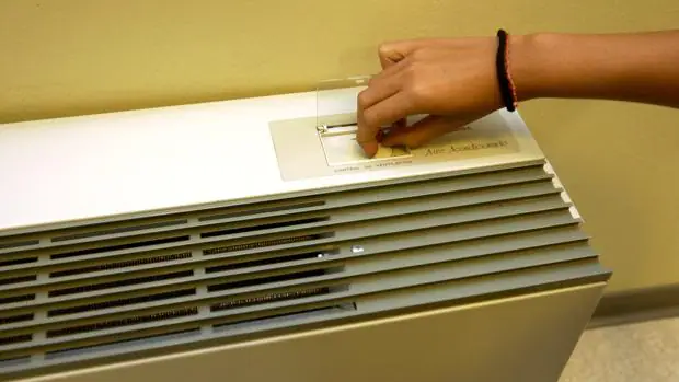 Una persona activa el aparato de aire acondicionado de su vivienda