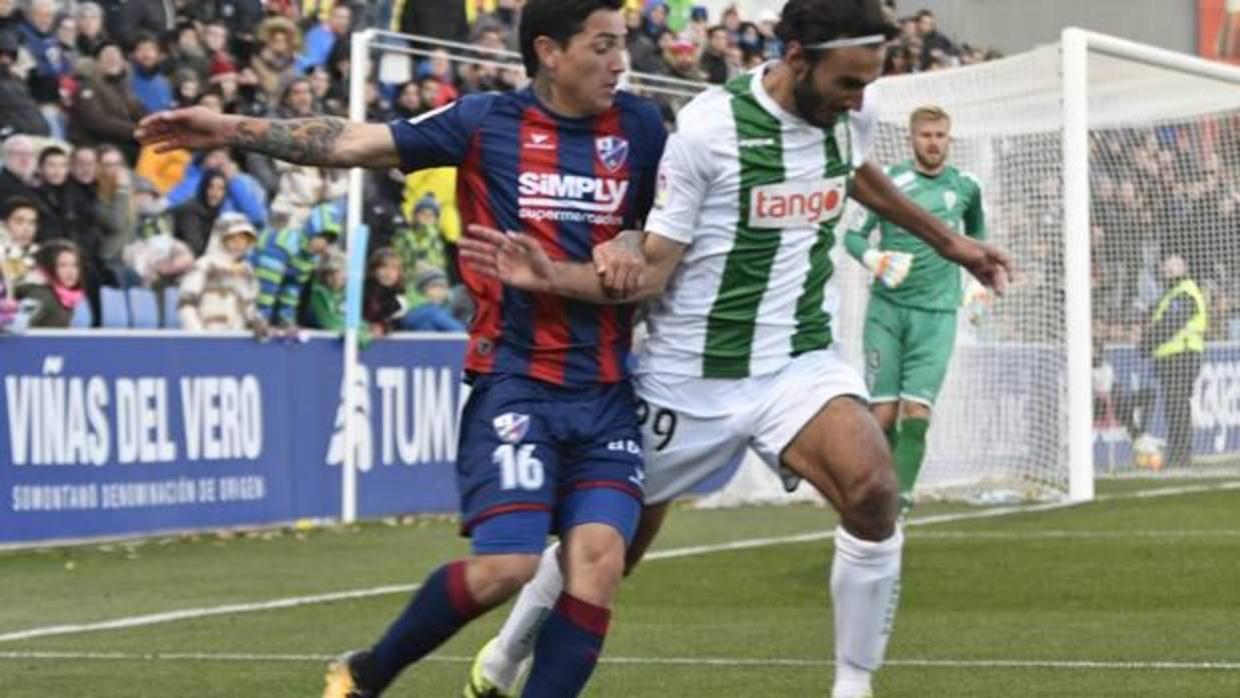 Javier Soler pelea la pelota con Ávila en el Huesca-Córdoba