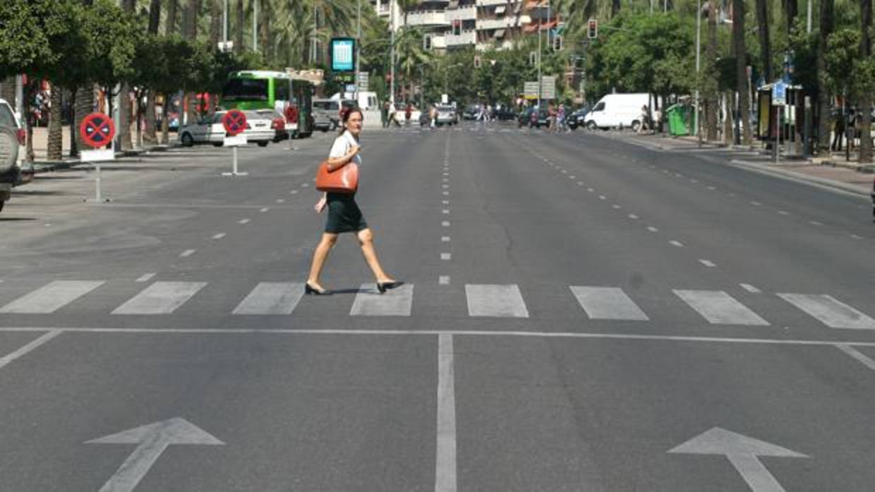 Una viadante cruza el Paseo de la Victoria de Córdoba