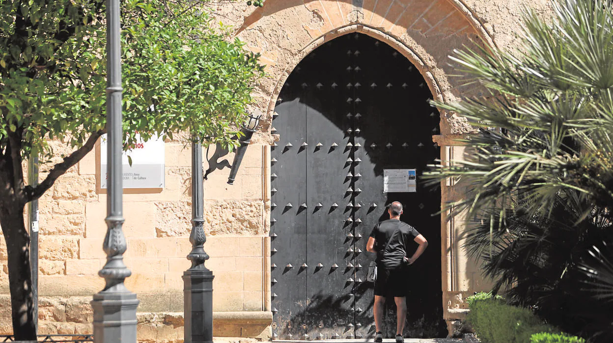 Un turista mira la puerta cerrada del Alcázar