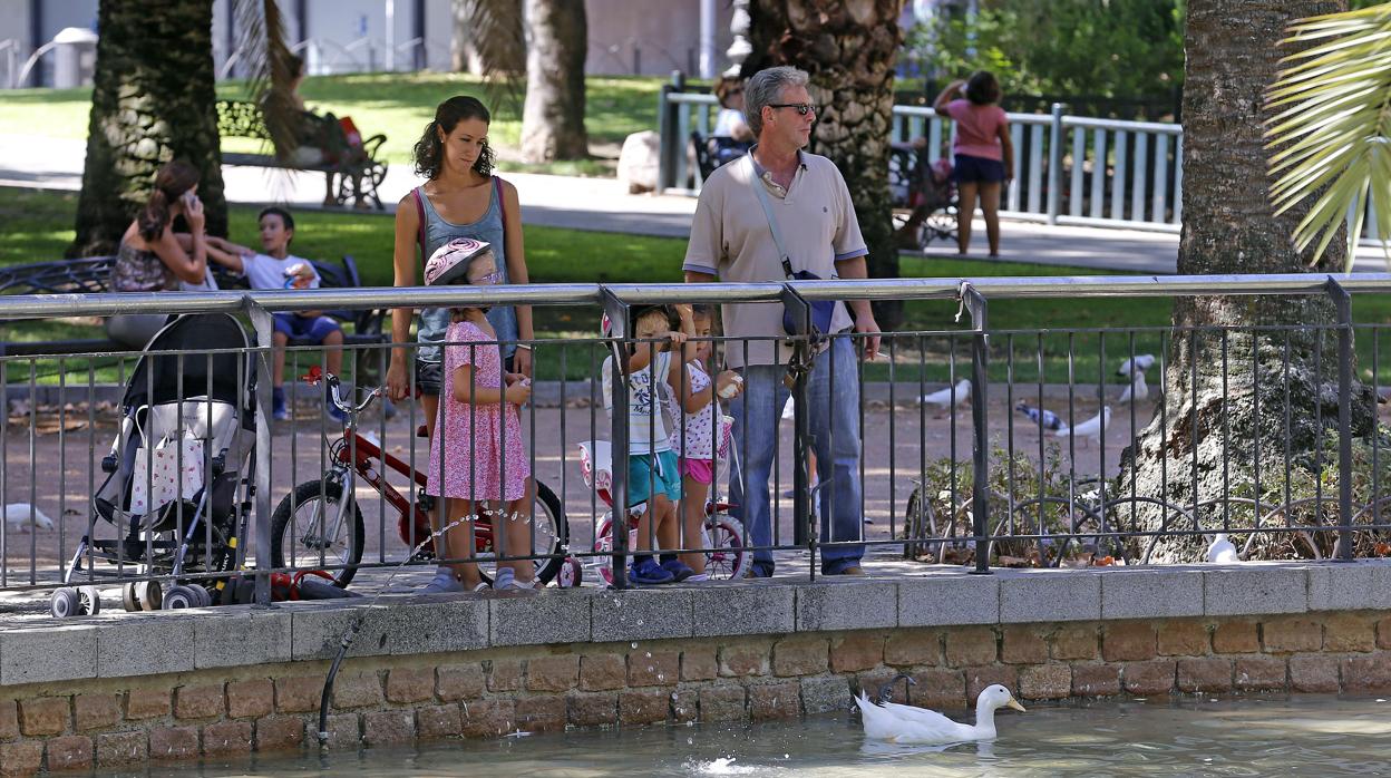 Una familia mira los patos en un parque de Córdoba