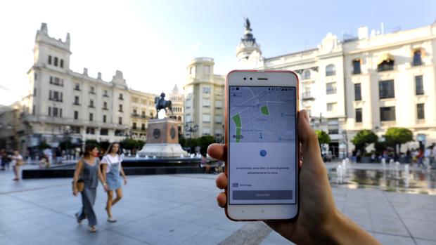 Una persona muestra su móvil con la aplicación de Uber en Las Tendillas