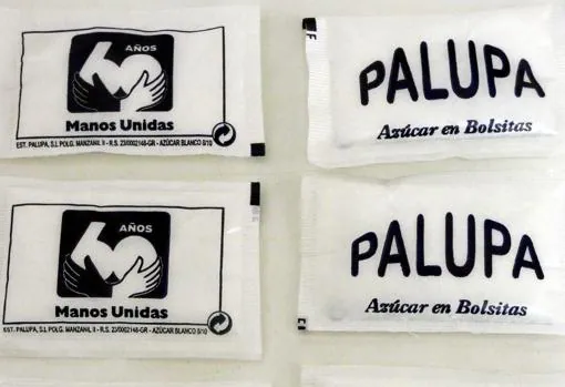 El logo conmemorativo de Manos Unidas, en los sobres de azúcar de Palupa.