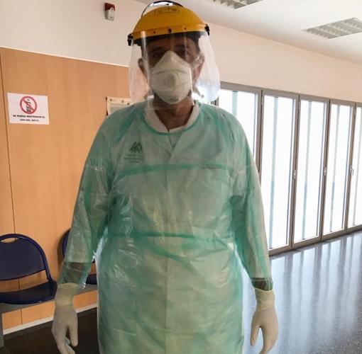 El médico José Antonio Prados, en su centro de salud protegido por una máscara, guantes y una bata