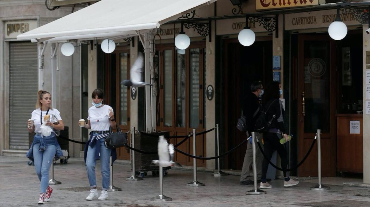 Dos chicas recogen su café en un local del centro de Málaga