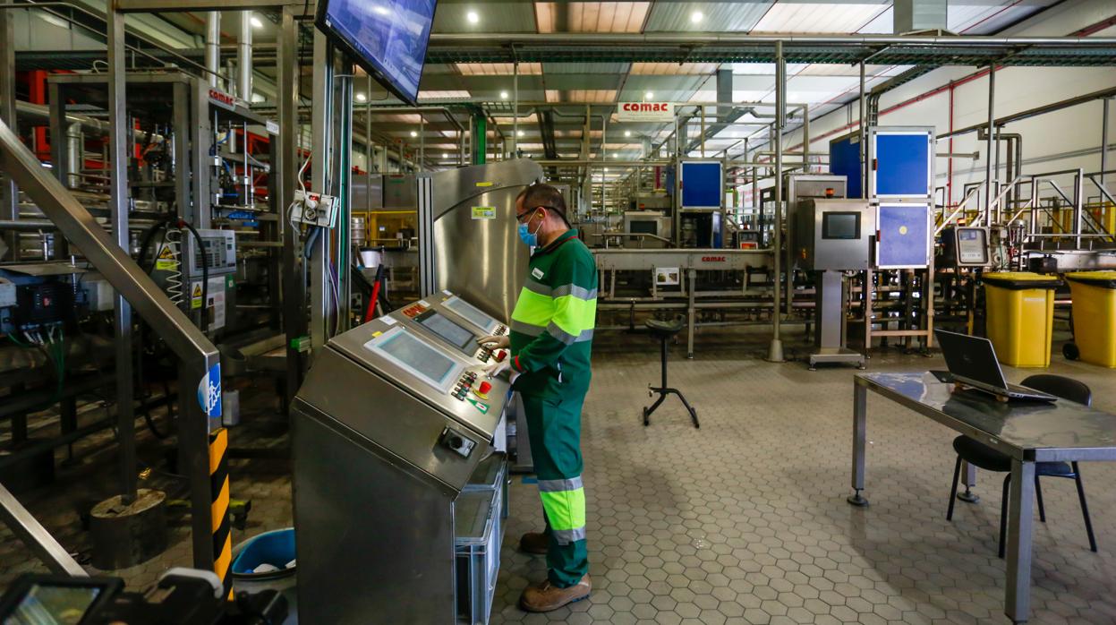 Un trabajador maneja una máquina en una fábrica