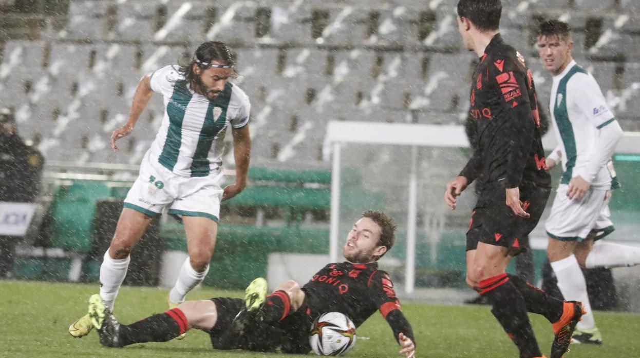 Mario Ortiz frena a Illarramendi en plena lluvia este miércoles en el Córdoba CF - Real Sociedad