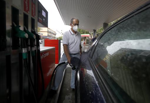 Un hombre reposta en una gasolinera de la capital