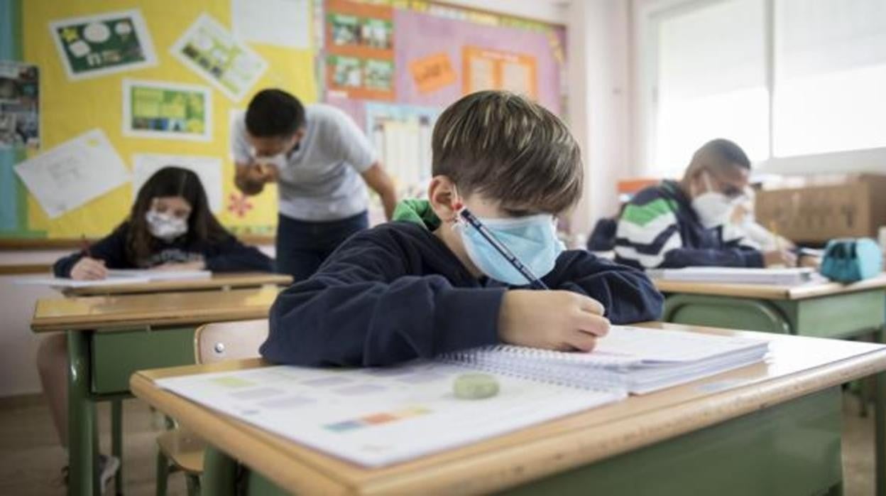 Niños en clase con la mascarilla