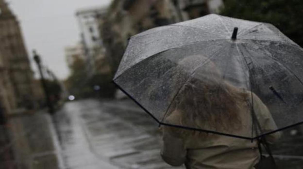 Una mujer se protege de la lluvia