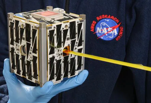 Un investigador de la NASA sostiene un «cubesat», un tipo de nanosatélite