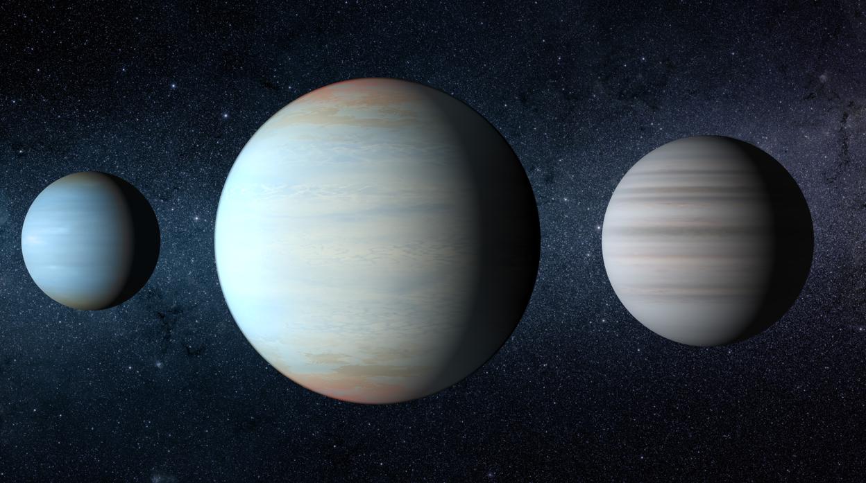 Recreación artística de los tres planetas del sistema Kepler-47. El gran planeta del medio es el recién descubierto