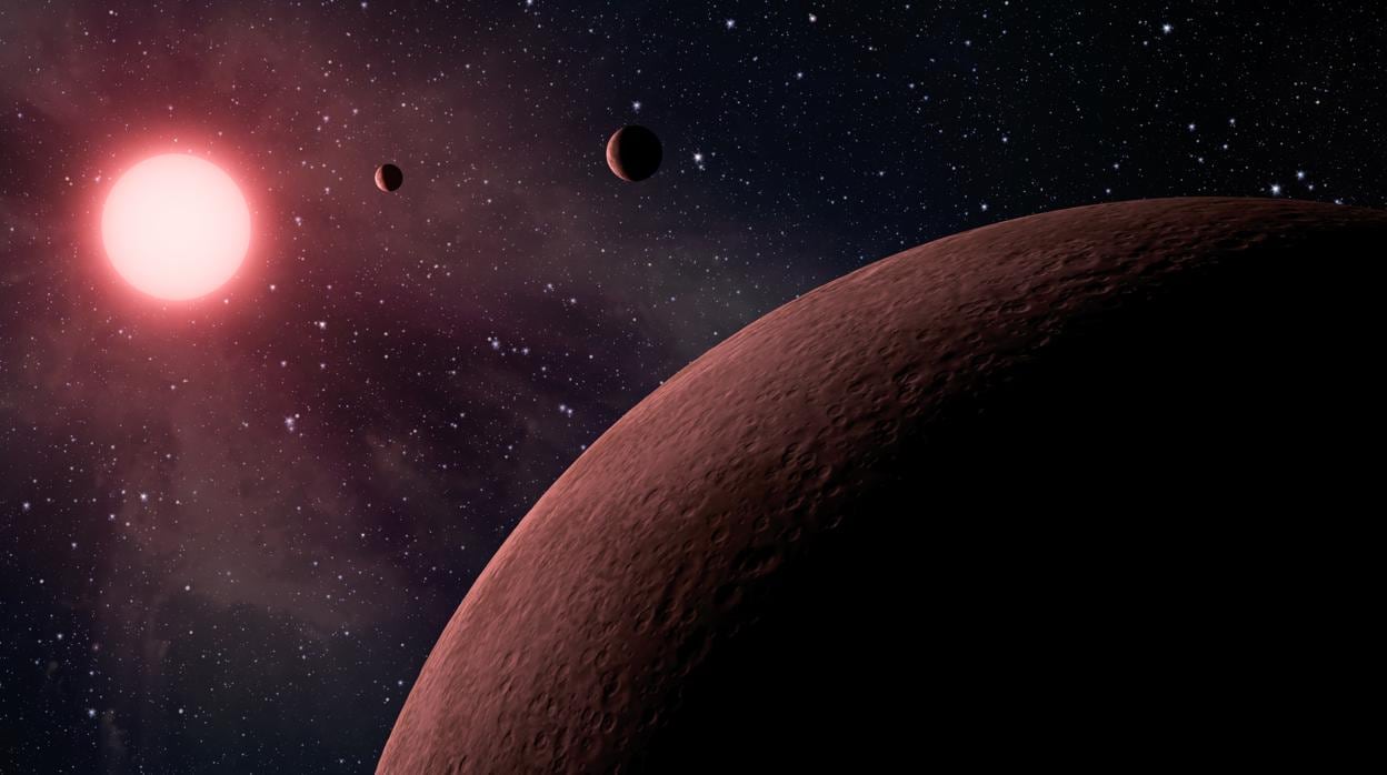 Representación artística del sistema solar de una estrella enana roja