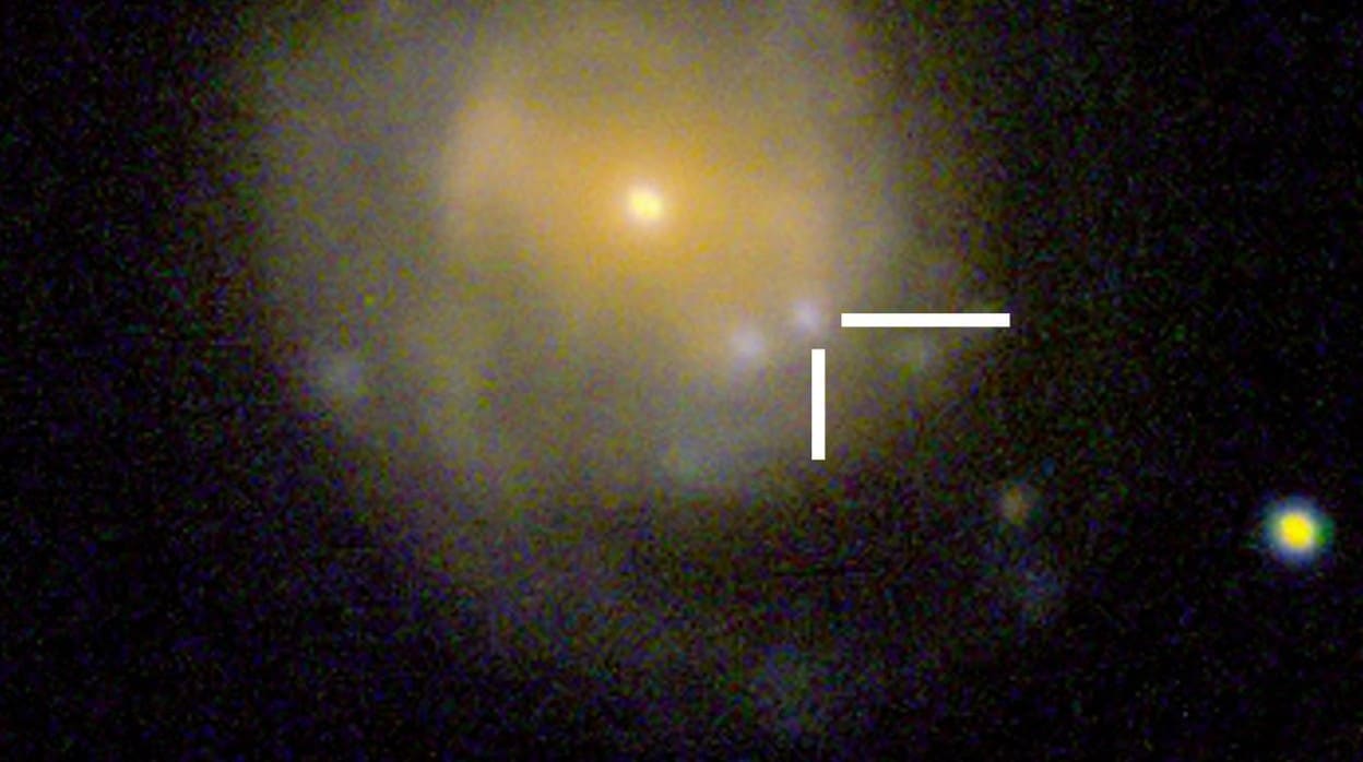 En la imagen, 'la Vaca', una extraña explosión estelar, aparece a la derecha de los dos puntos brillantes bajo el centro de una galaxia a 200 millones de años luz de distancia
