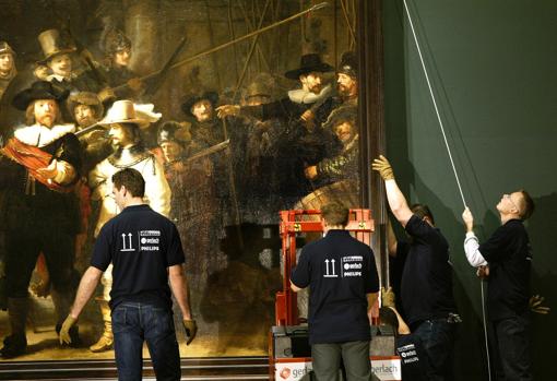 Trabajadores del museo holandés, descolgando el cuadro en 2003, que fue trasladado por última vez durante las obras de restauración del Rijksmuseum