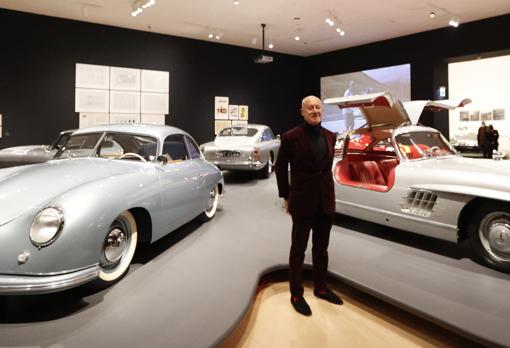 Norman Foster, junto a algunos coches presentes en la muestra