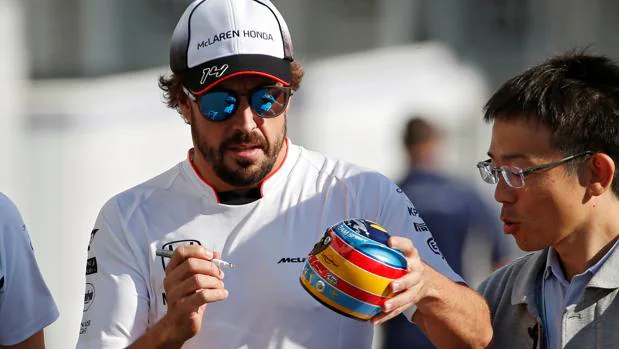 Fernando Alonso firma una réplica de un casco en Suzuka