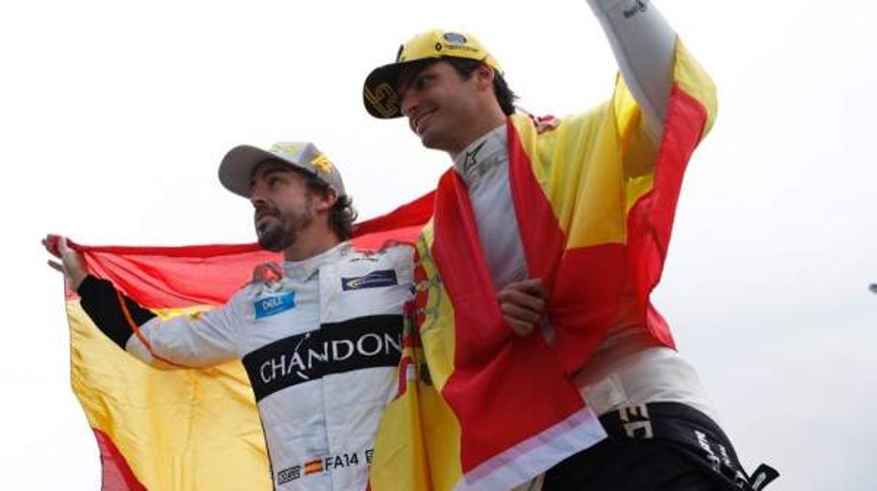 Fernando Alonso y Carlos Sainz con una bandera de España