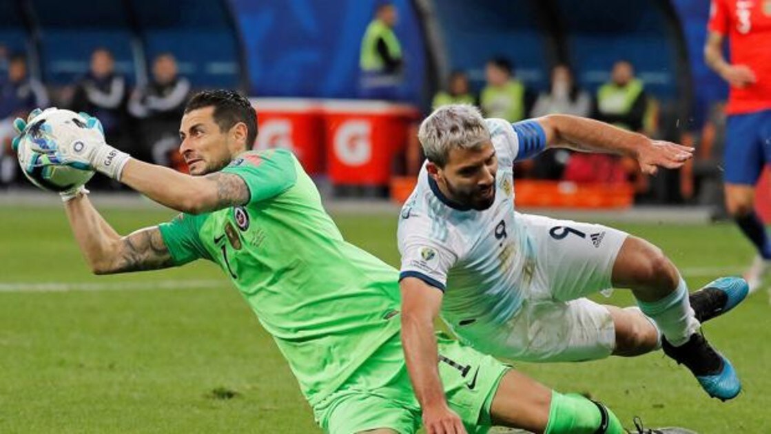 El jugador de Argentina Sergio Agüero (d) disputa el balón con Gabriel Arias de Chile,