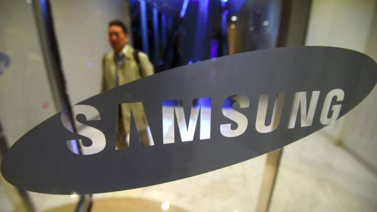 Un hombre pasea detrás del logo de Samsung Electronics