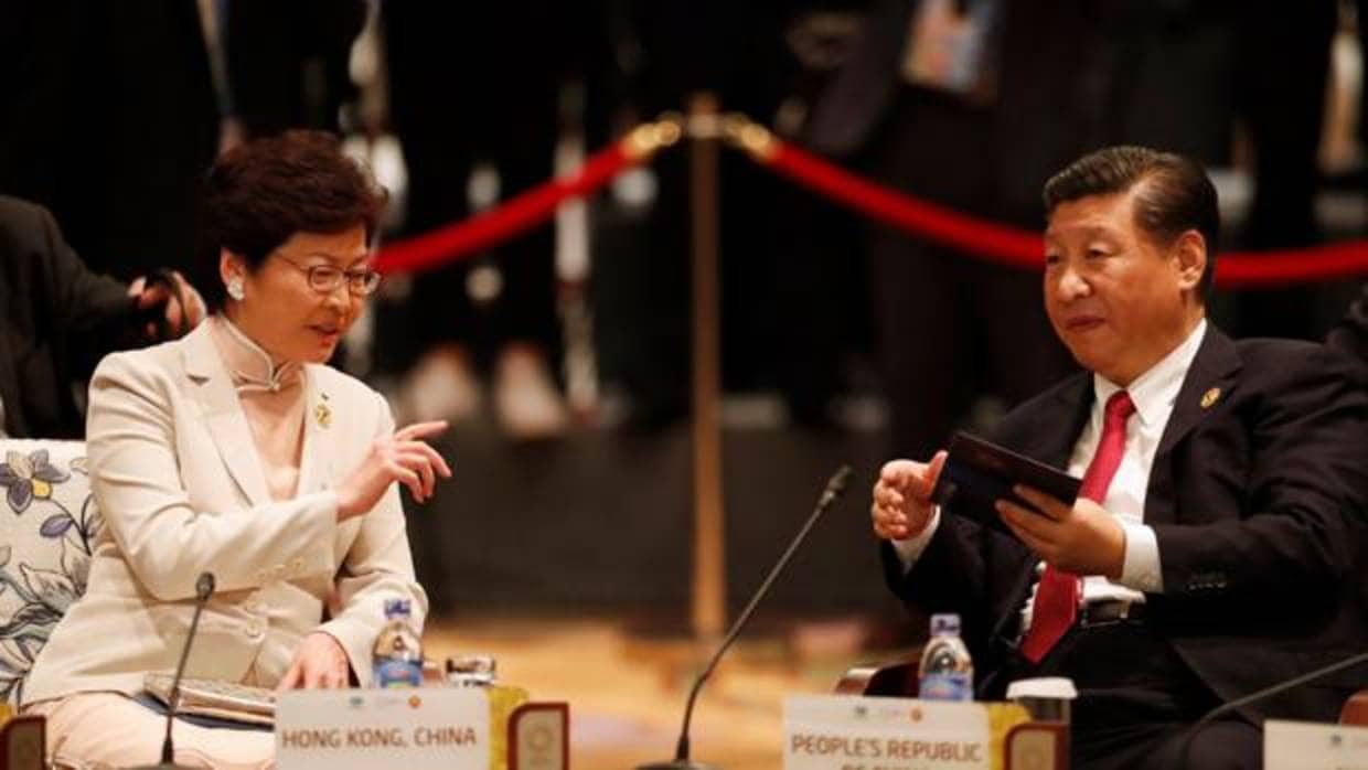 El presidente chino, Xi Jinping (dcha), conversa con la jefa ejecutiva de Hong Kong, Carrie Lam, mientras asisten a la cumbre de diálogo APEC-ASEAN