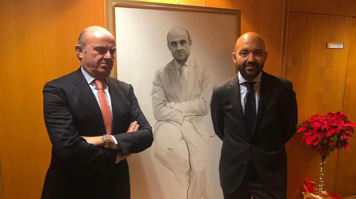 El exministro de Economía Luis de Guindos, junto a su retrato y el ex secretario de Estado Jaime García-Legaz