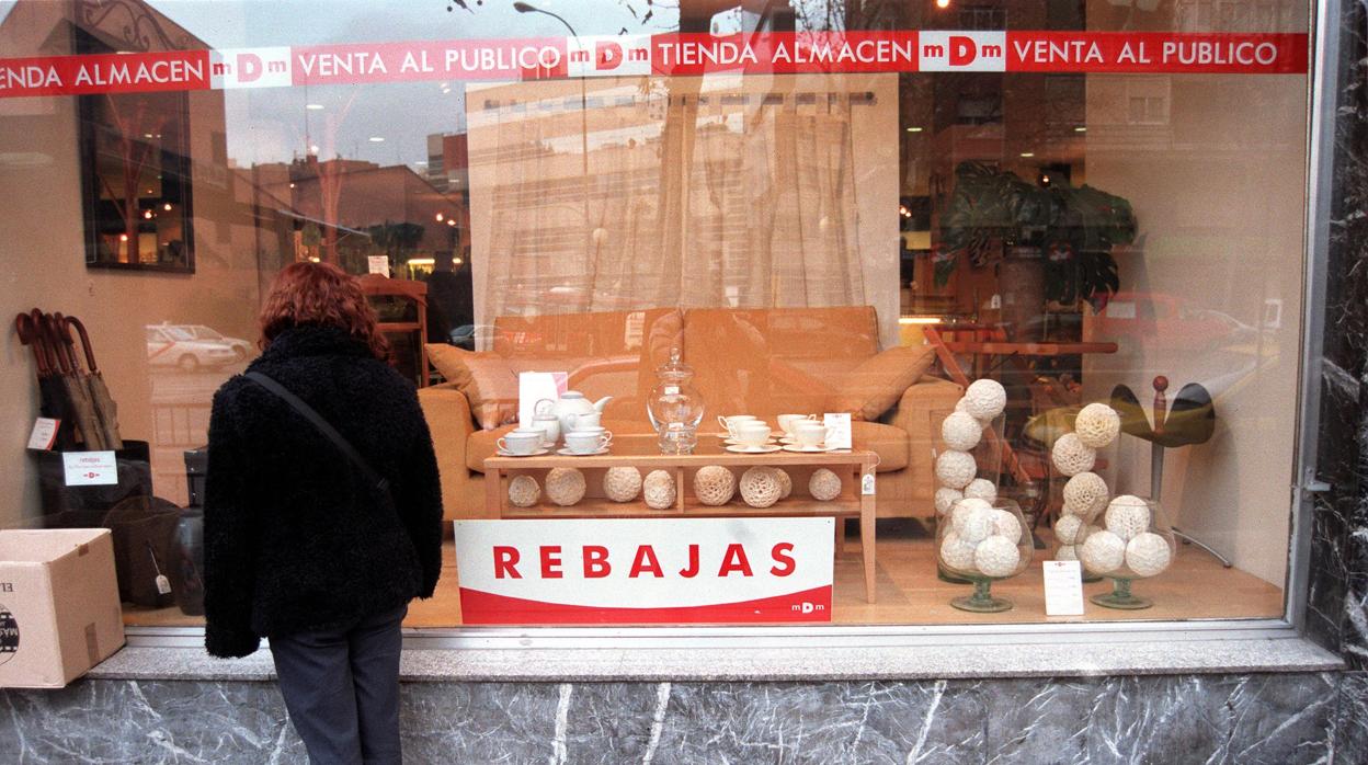 Una mujer se fija en una tienda de muebles de Madrid