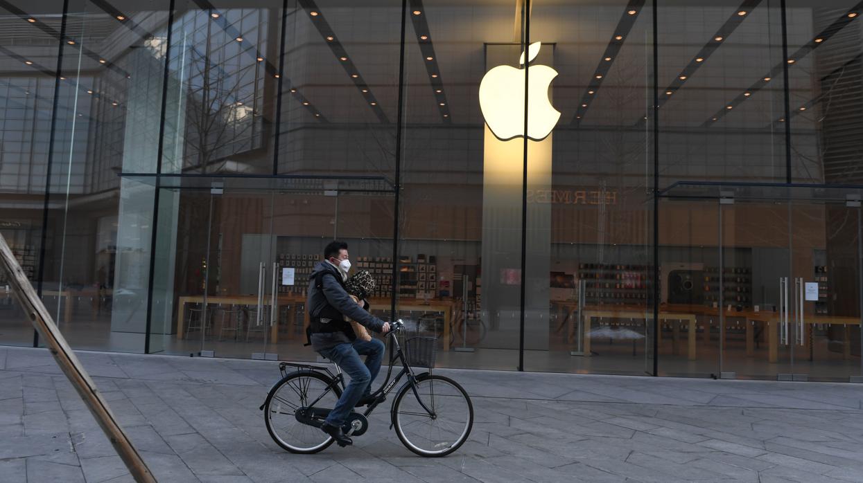 Una persona pasa cerca de una tienda de Apple