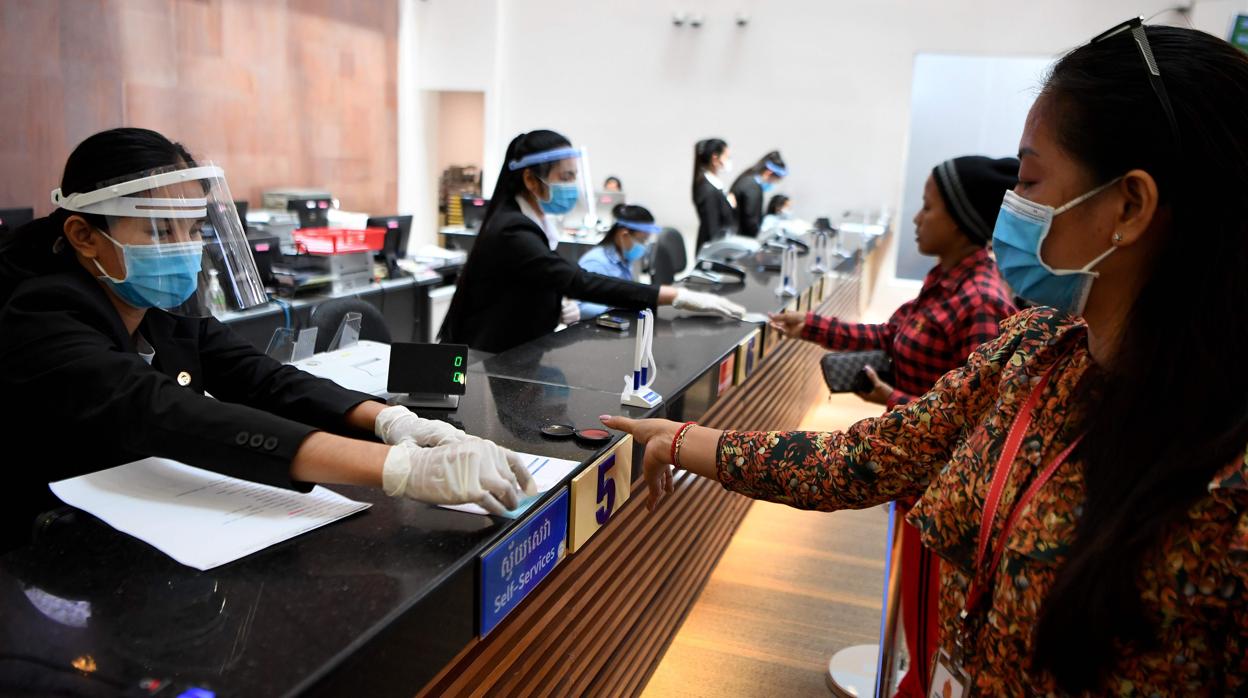 Clientes y cajeros de un banco de Phnom Penh este mes de marzo