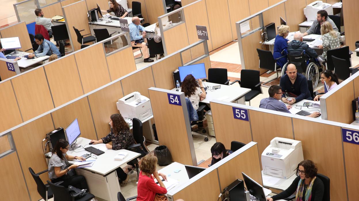 Funcionarios atendiendo al público en una oficina de la Agencia Tributaria, en Madrid