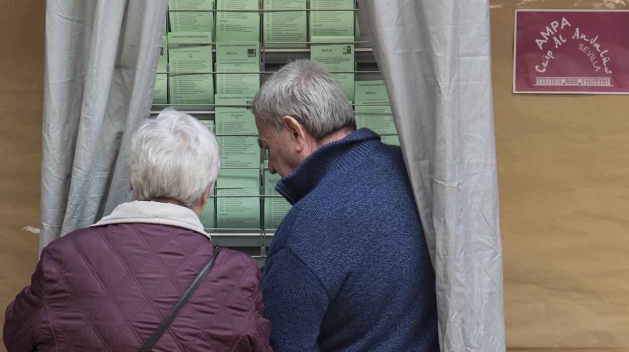 Dos votantes hoy en un colegio electoral de Sevilla