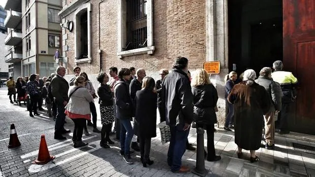 Cola de votantes esperando su turno para acceder al colegio electoral en Valencia