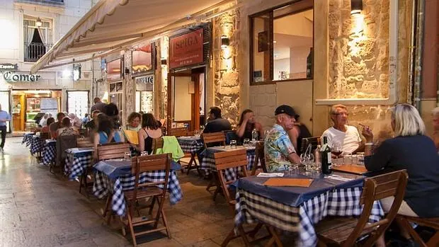 Comensales en la terraza de un restaurante de comida italiana en Alicante.