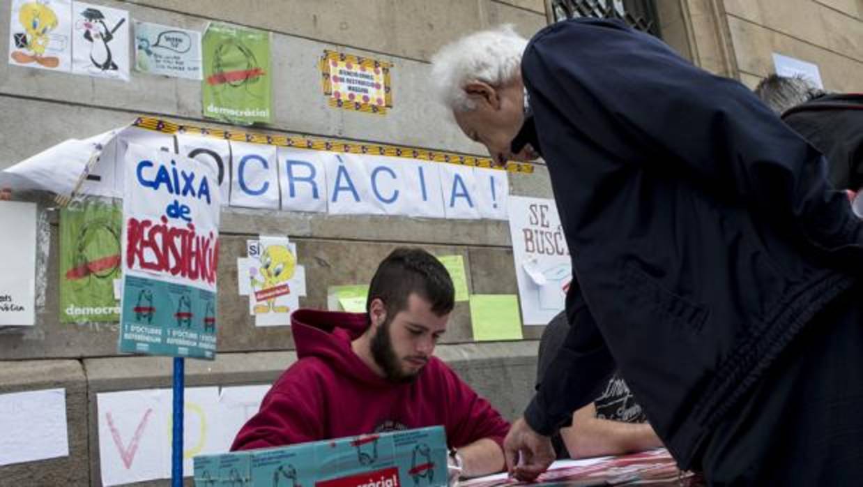 Estudiantes a las puertas de la Universidad de Barcelona informan a la gente sobre los colegios en los que votar el referéndum del 1-O, además de recaudar dinero para la caja de resistencia