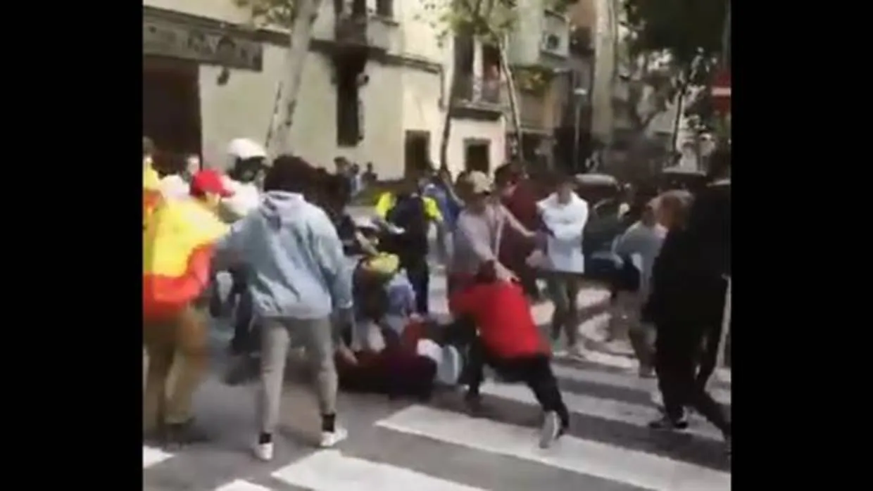 Un centenar de jóvenes, unos con banderas españolas y otros con enseñas independentistas catalanas, protagonizaron una batalla campal este martes en Barcelona