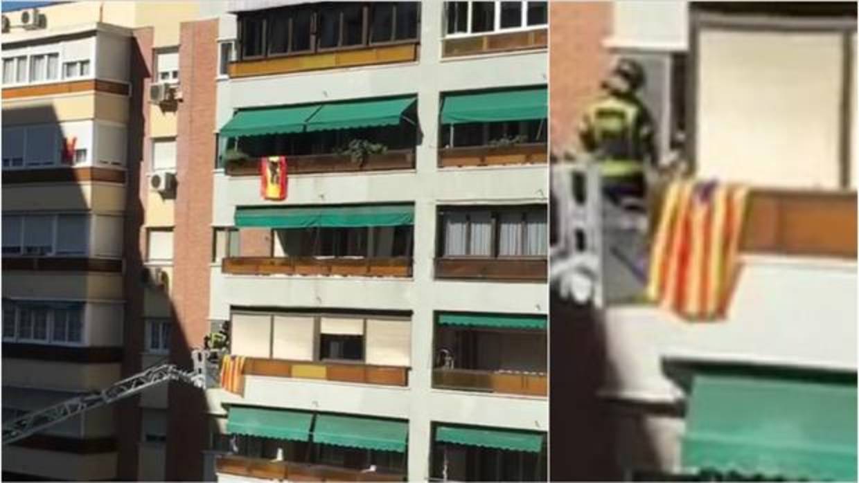 Un bombero durante la intervención en el balcón, con la estelada colgada