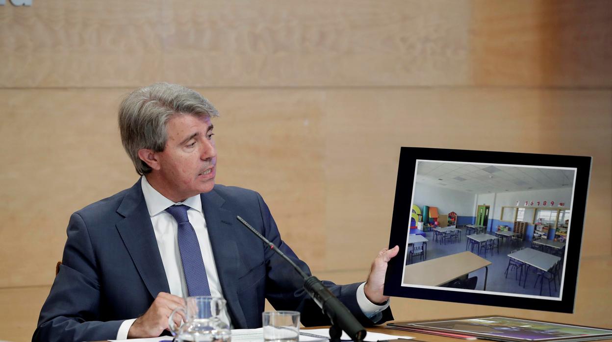 Ángel Garrido, presidente de la Comunidad de Madrid, muestra la fotografía de un aula habilitada por obras en el comedor del colegio Alfredo di Stefano, de Valdebebas