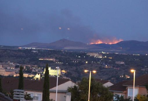 El fuego, visto el martes por la noche desde la urbanización La Legua, en Toledo capital, a más de 15 kilómetros de distancia (fotografía). Abajo, en el vídeo, las llamas queman la sierra