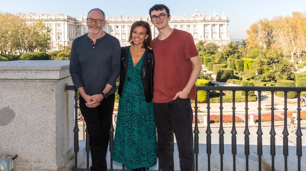 Los actores Isaac Hempstead-Wright y Liam Cunningham posan junto a la delegada de Turismo, Almudena Maillo, frente al Palacio Real